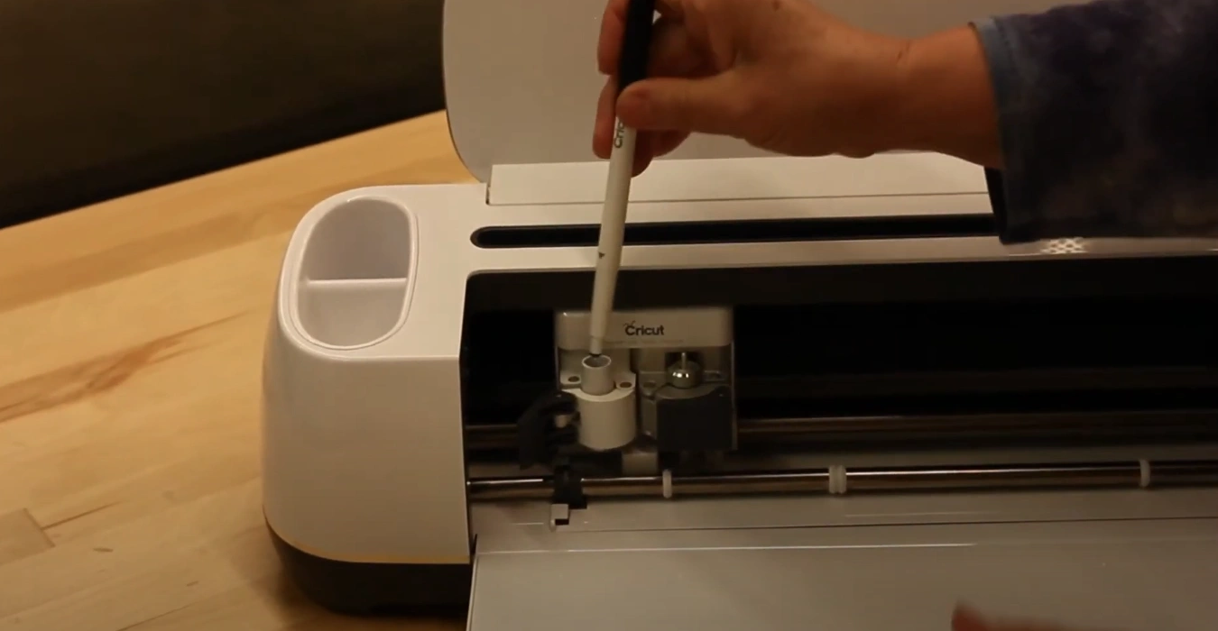 Slide the pen into the holder with the two grooves facing up