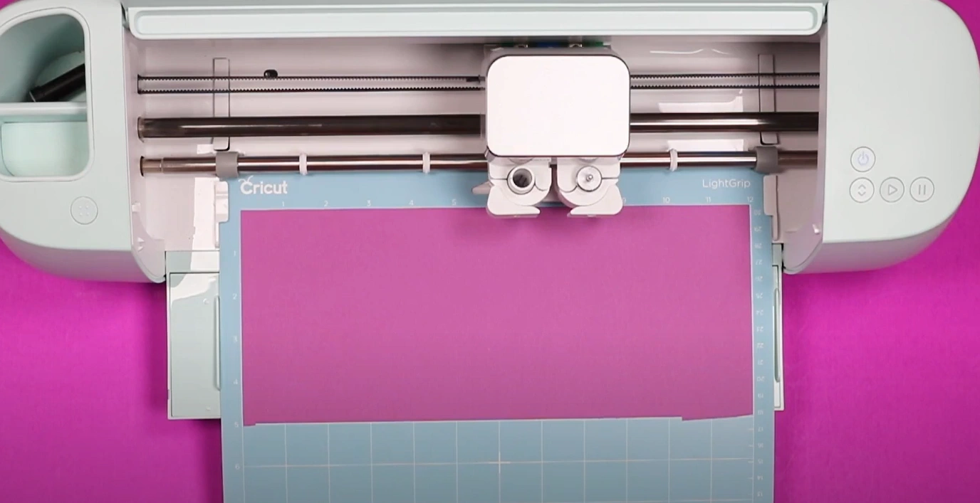 Load the mat with the cardstock into the Cricut