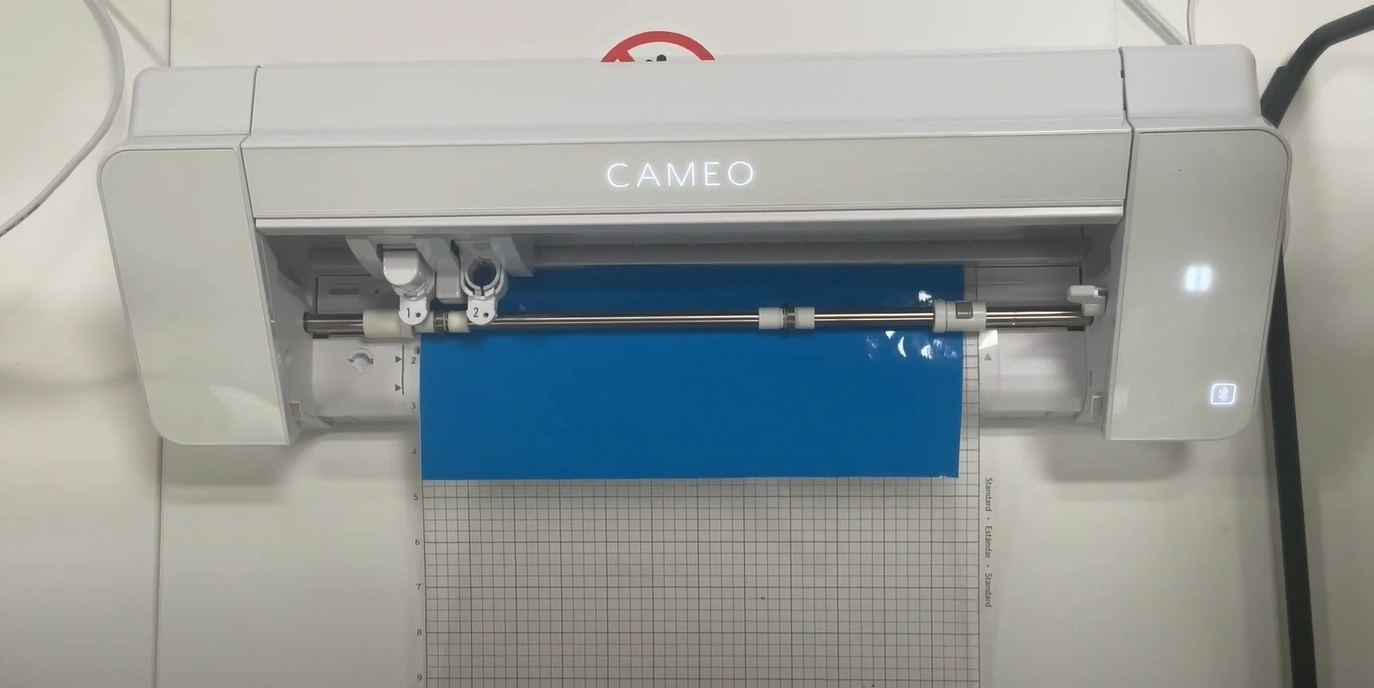 It will cut a small square with a triangle in the middle. Peel it off to check the settings