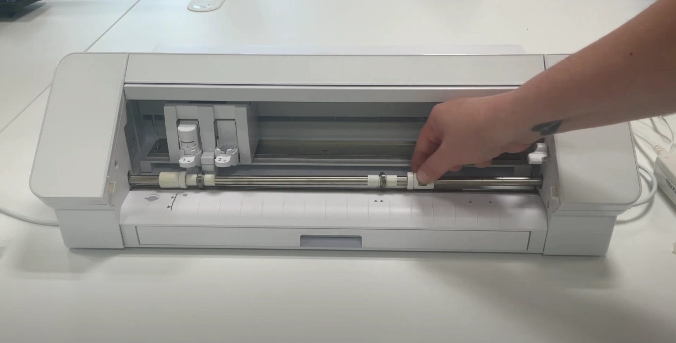 Move the rollers by lifting the lever on the right and sliding them across the surface